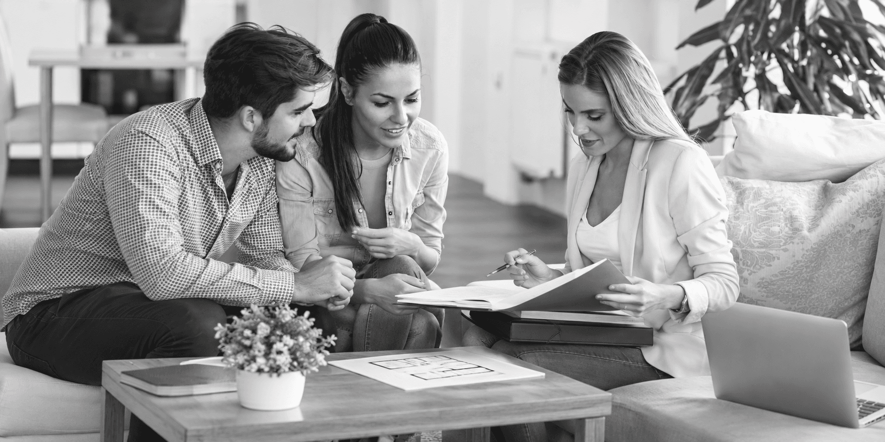 Three people reviewing documents together
